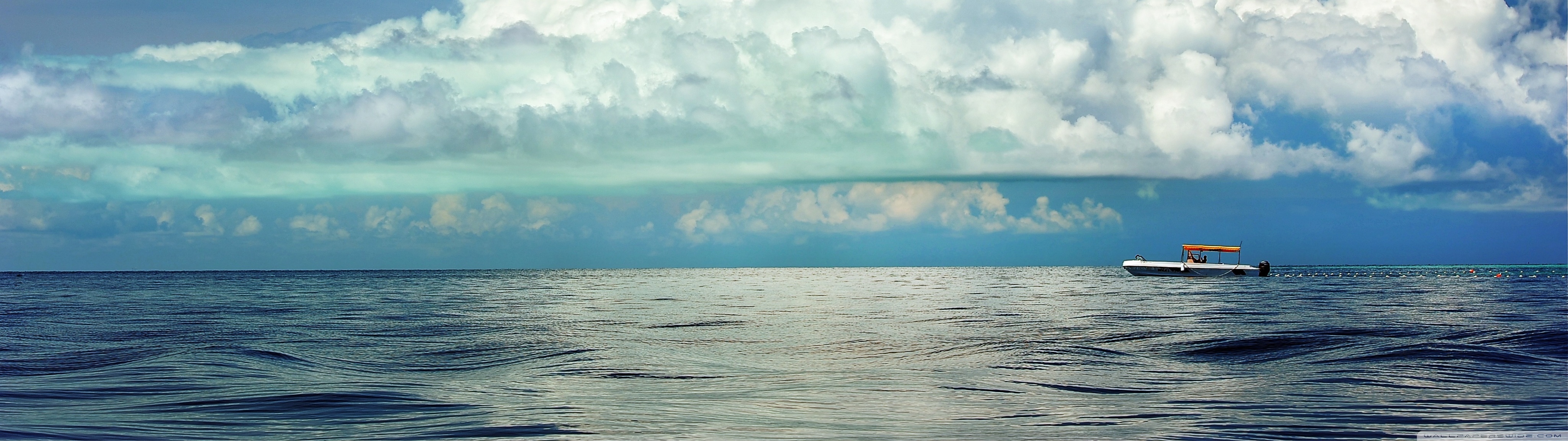 cumulus_clouds_above_the_sea-wallpaper-4096x1152.jpg