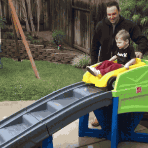 dad-push-kid-car-slide-wipeout.gif